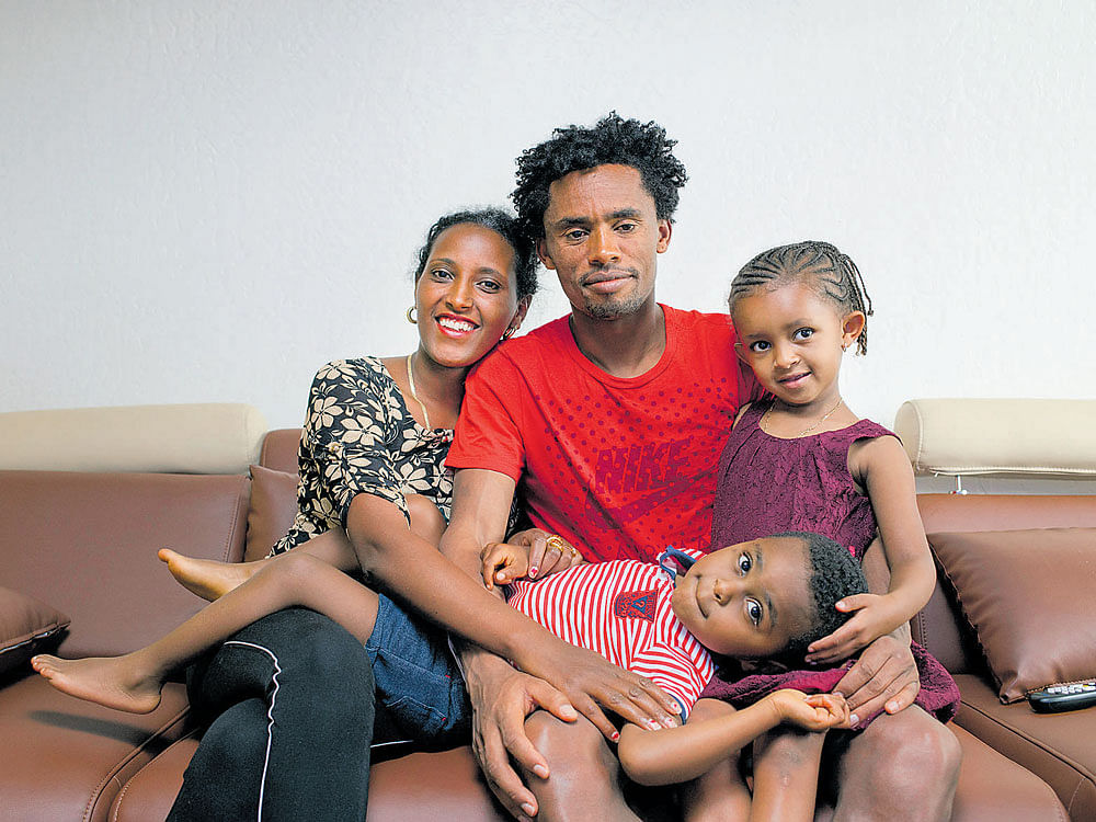 family time: Feyisa Lilesa was recently reunited with his wife Iftu Mulisa and kids Soko (right) and Sora. nyt