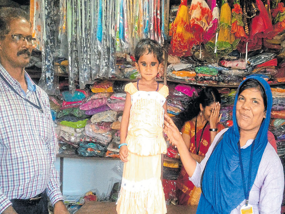Nargees (right) with little Mizriya at the garment store.