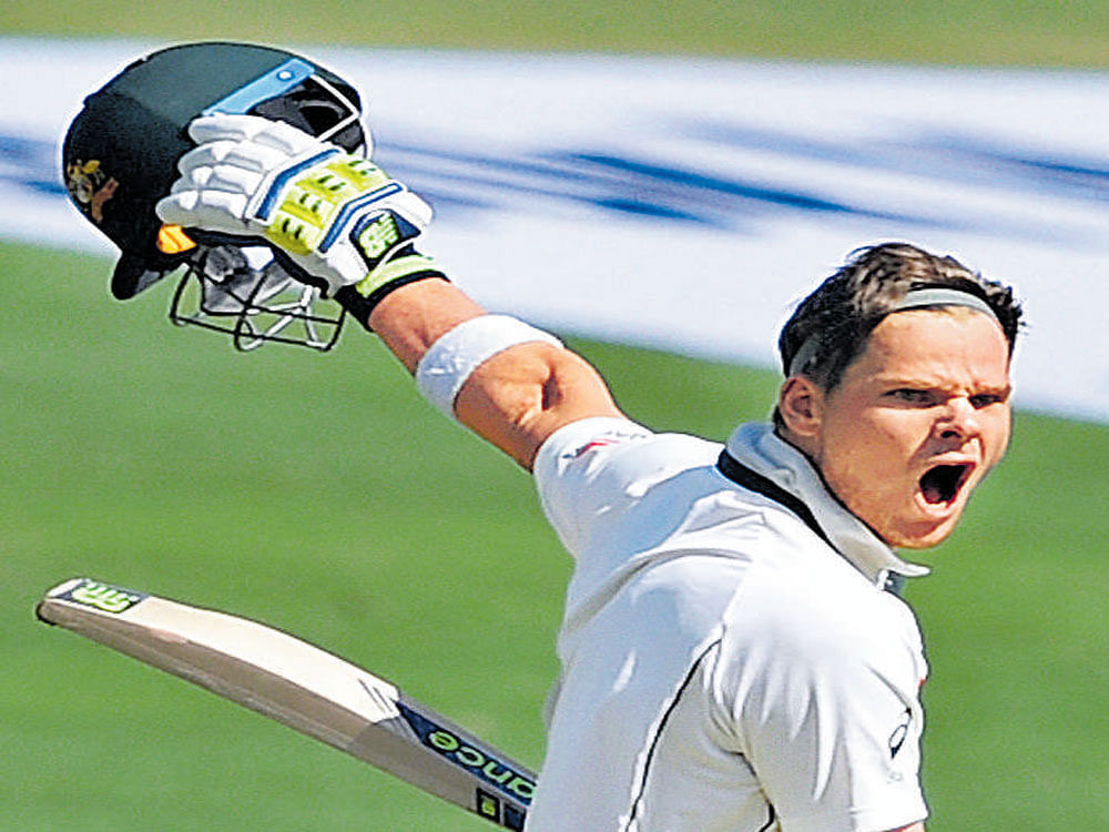 Australian counterpart Steve Smith is jubilant after scoring a century on the third day of the opening Test at the MCA Stadium in Pune.  pti