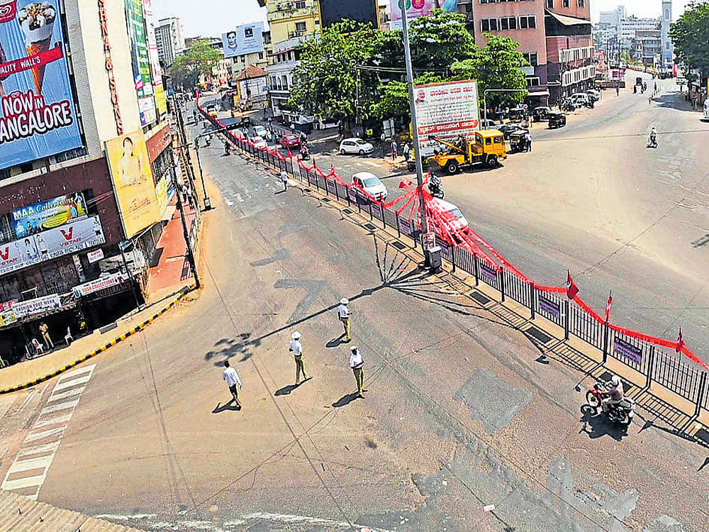 The ever-busy Hampankatta Circle wears a deserted look on account of a hartal call on Saturday. DH photo