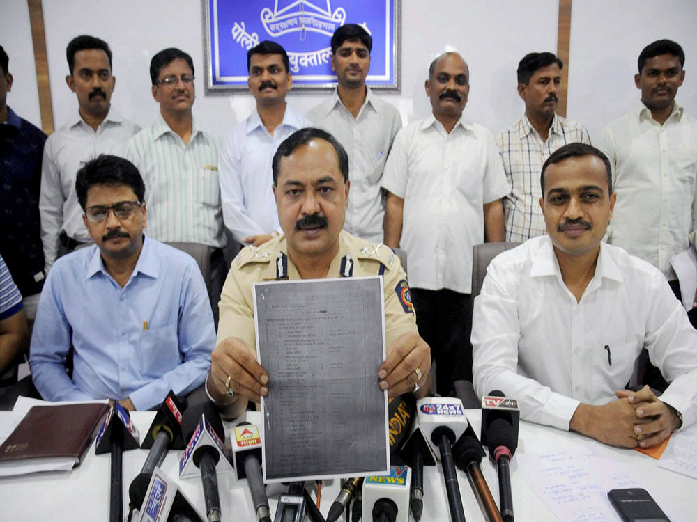 Thane Crime Branch-CID officials show a leaked exam paper in Mumbai. PTI photo
