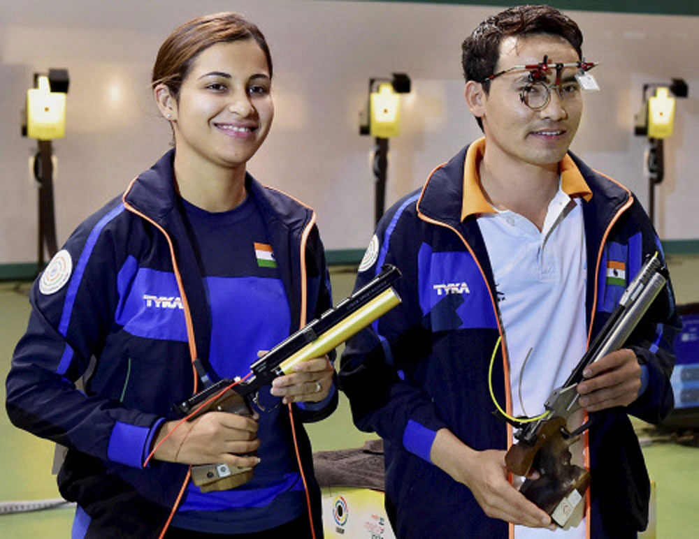 India's Heena Sidhu and Jitu Rai celebrate after winning the mixed team 10m Air Pistol event of the ISSF World Cup in New Delhi on Monday. PTI Photo