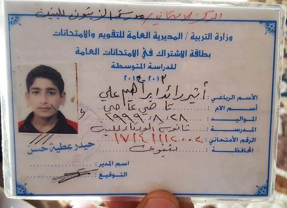 The ID card/childhood photo of teenage Islamic State militant Atheer Ali is seen in Mosul, Iraq, February 4, 2017. Picture taken February 4, 2017. REUTERS