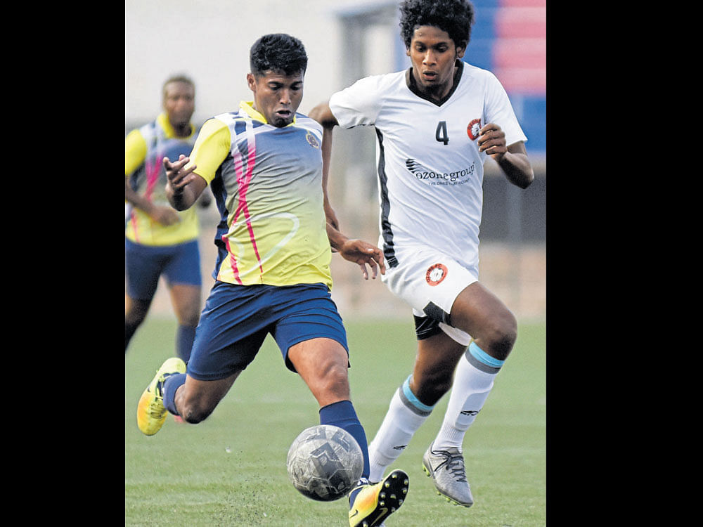 on the move ASC's Sreejith KP (left) makes a run past Vivekananda of Ozone FC on Wednesday. DH photo