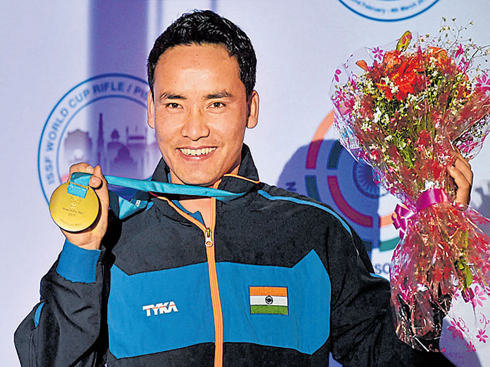 Bull's eye: India's Jitu Rai with his gold medal after triumphing in the 50M pistol event on Wednesday. PTI