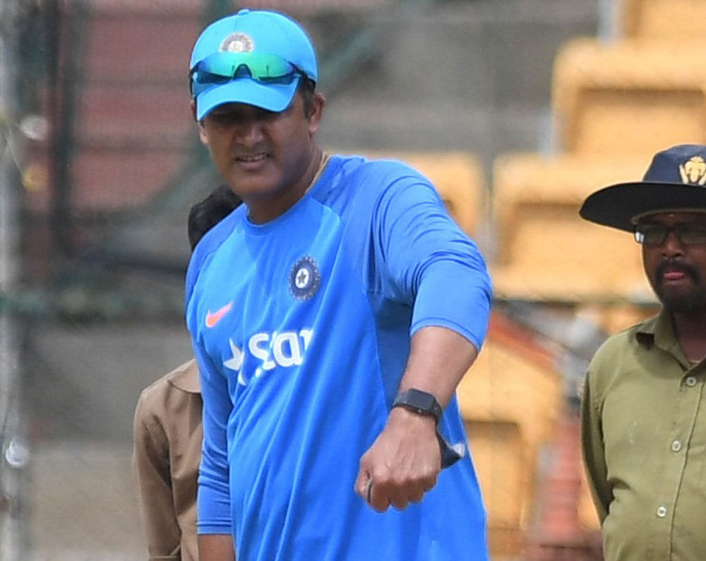 Indian coach Anil Kumble takes a look at the pitch at the Chinnaswamy stadium.