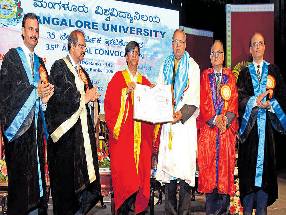 Minister for Higher Education Basavaraj Rayareddi confers Honoris Causa degree on folklorist Prof B A Viveka Rai at the 35th annual convocation of Mangalore University on Friday.