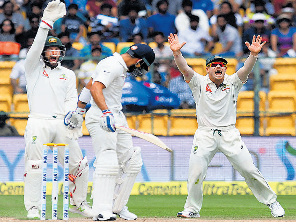 Howzzat!! Australians successfully appeal against Virat Kohli (centre)&#8200;on day one of the second Test. DH photo