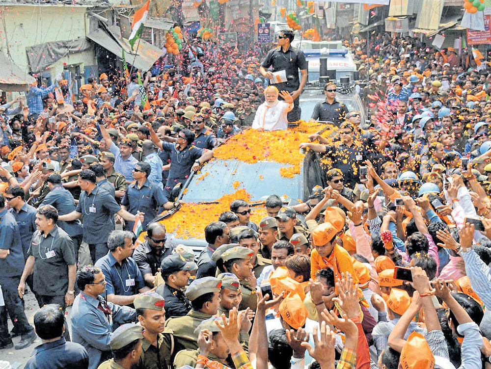 A huge crowd gathers at Prime Minister Narendra Modi's roadshow in Varanasi. PTI