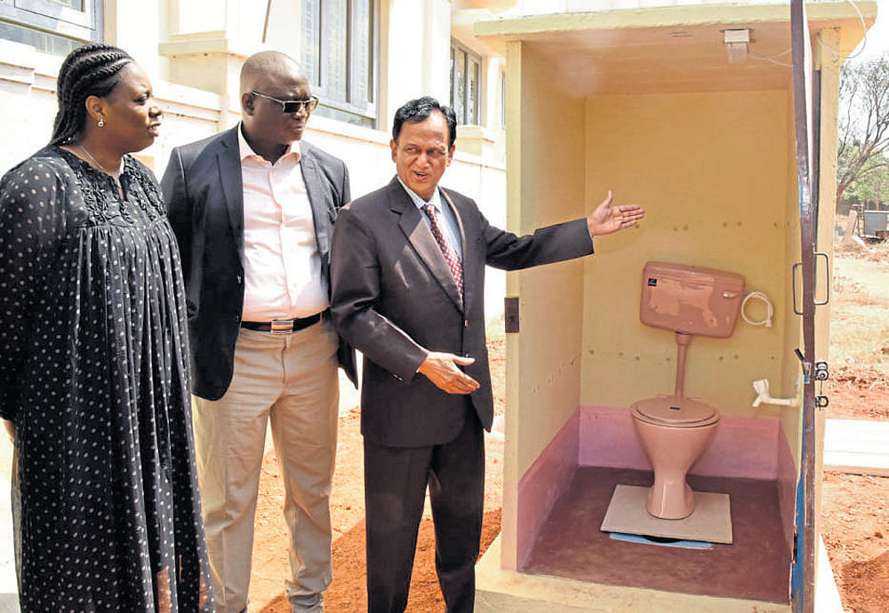 H Raja Simha, retired Isro chief engineer (extreme right),  explains the model of precast toilets to Seydon Sane, Mayor of Ziguincho (centre),&#8200;and Ndeye Fatou, general manager of ABC (left)&#8200;from Senegal, in Bengaluru on Saturday. DH Photo