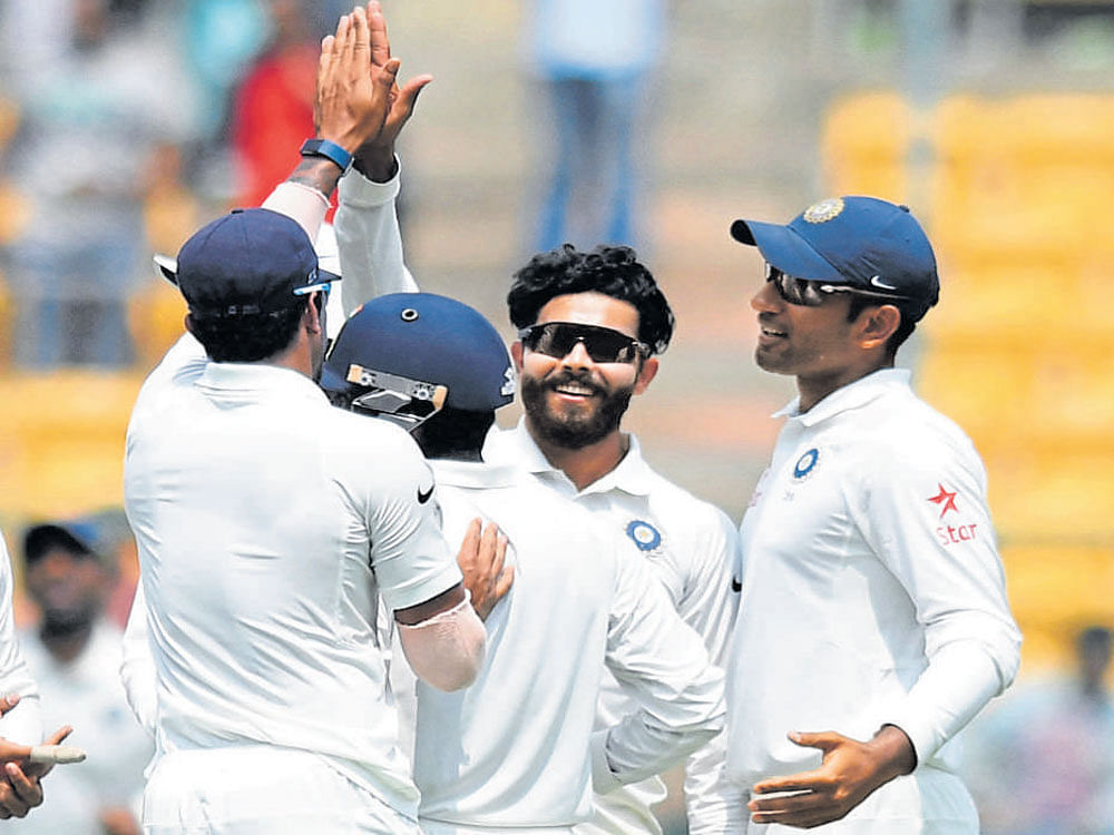 Delighted Ravindra Jadeja (centre) celebrates the wicket of Matt Renshaw with team-mates. DH photo