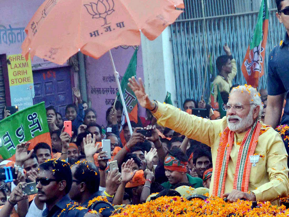 Modi, who began his roadshow from Pandepur Crossing, traversed through Chowkaghat, Hukulganj and Teliabagh before culminating at Kashi Vidyapeeth, where he addressed a rally. PTI Photo.