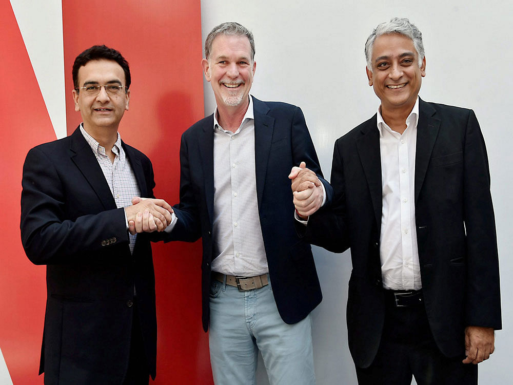 (L-R) Director Commercial for Vodafone India, Sandeep Kataria; Co-Founder and CEO of Netflix, Reed Hastings and COO Videocon d2h Limited Himanshu Patil, at Netflix's multi-platform partnerships announcement in New Delhi on Monday. PTI Photo