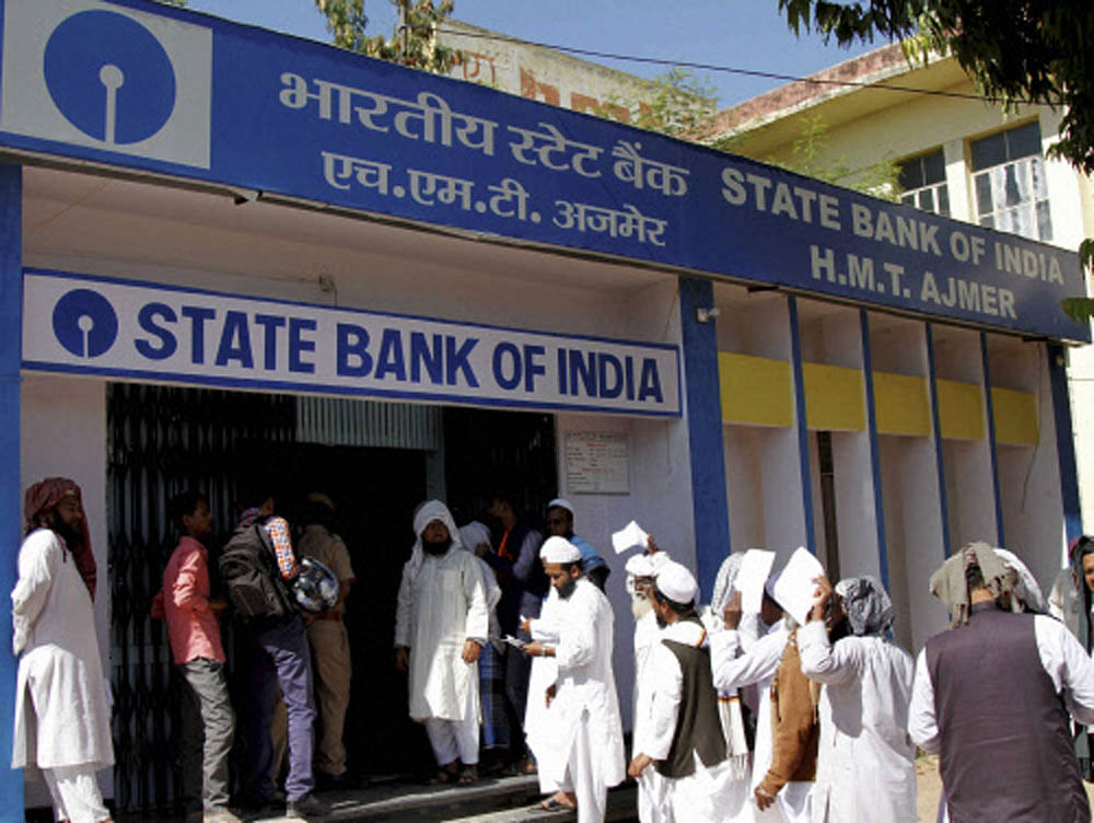Savings bank account holders of SBI and its five associates (merging with it on April 1) will have to maintain the monthly balance or else they will invite a penalty ranging from Rs 20 (rural branches) to Rs 100 in (metro cities). SBI has 31 crore savings bank accounts. PTI file photo