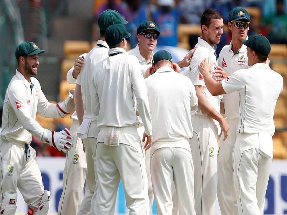 Australia's Josh Hazlewood (3rd R) celebrates the wicket of India's Cheteshwar Pujara. REUTERS/Danish Siddiqui
