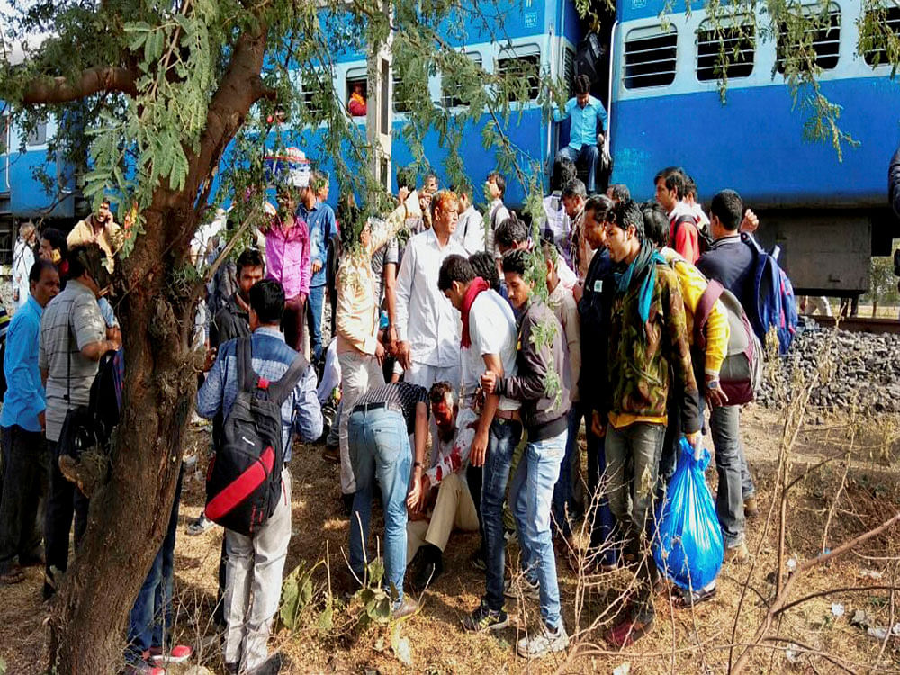 People attend to an injured person after a blast in the Bhopal-Ujjain passenger train near Jabdi station in Shajapur district in Madhya Pradesh. PTI Photo