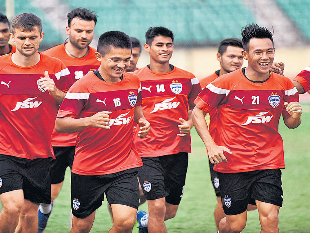 Ready to go : Bengaluru FC players train ahead of their tie against Chennai City FC on Wednesday. AFP