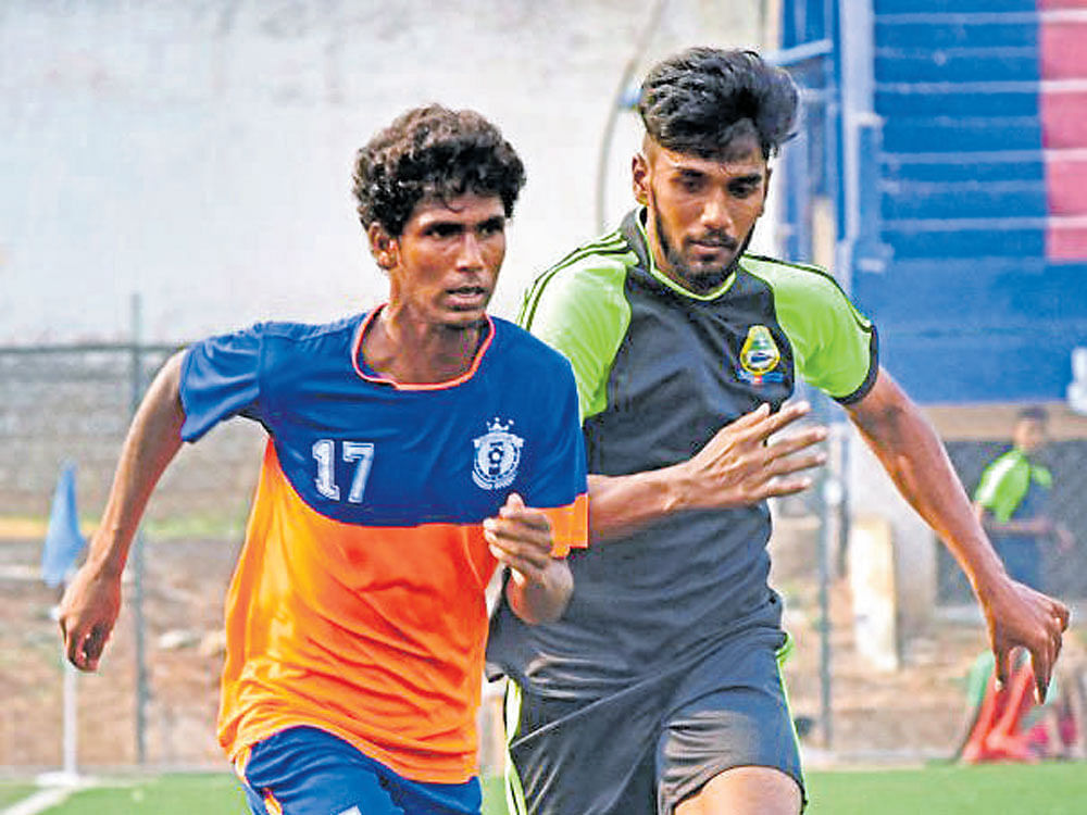 out of my way!  Shivakumar of DYES (left) and Mithun of RWF vie for possession in the Super Division League. dh photo