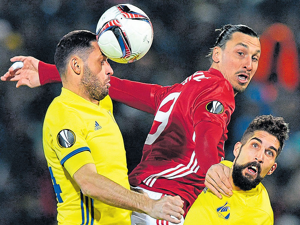tough battle: Manchester United's Zlatan Ibrahimovic (centre) is challenged by Rostov's Aleksandr Gatskan (left) and Miha Mevlja during their Europa League last-16 clash on Thursday. AFP
