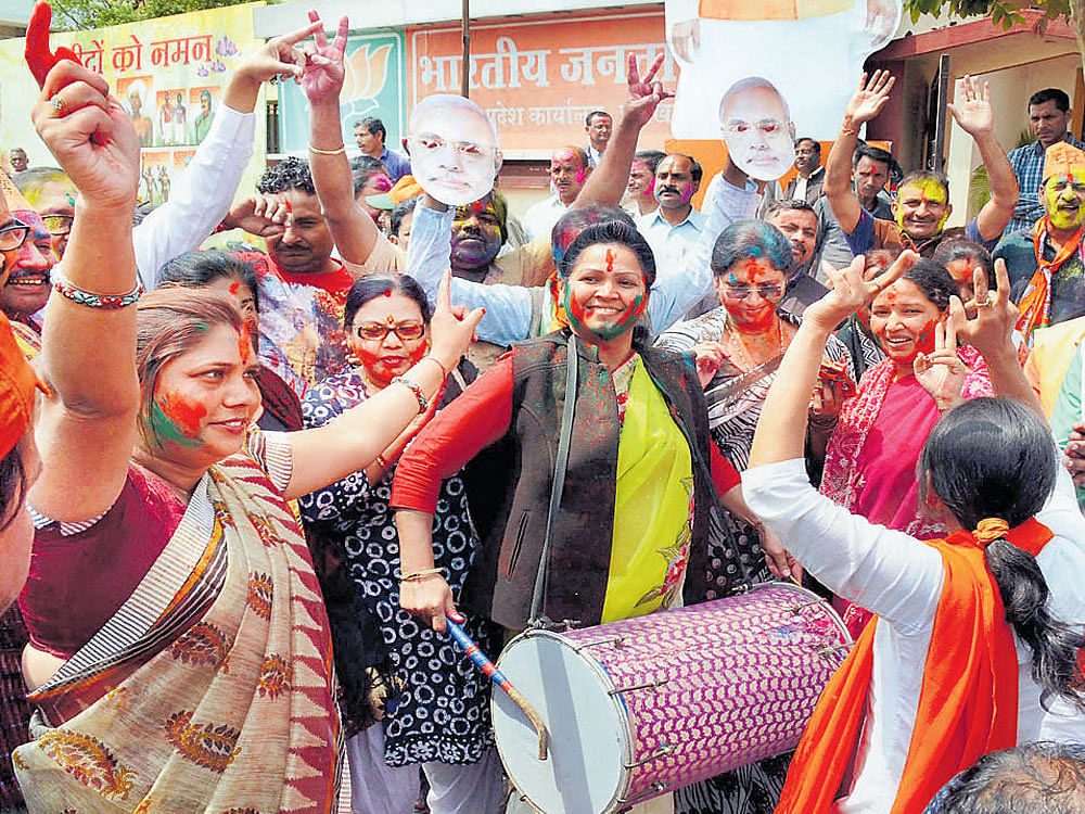 BJP women workers in Ranchi celebrate the party's victory in UP and Uttarakhand Assembly polls on Saturday. PTI