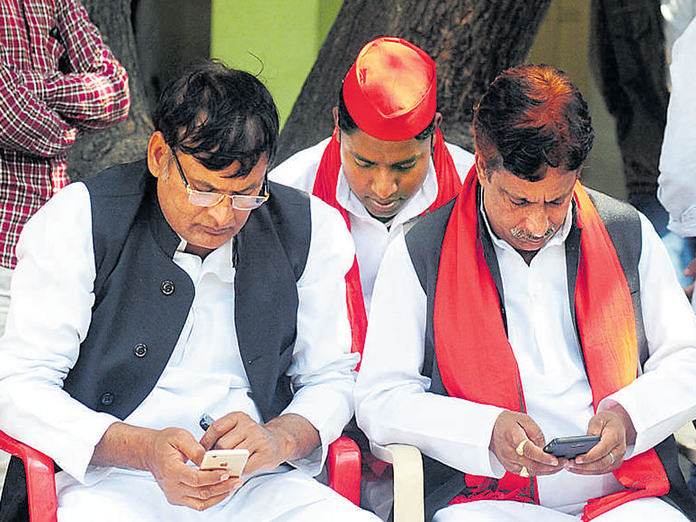 SP supporters discuss the dismal performance at the party office in Lucknow. AFP