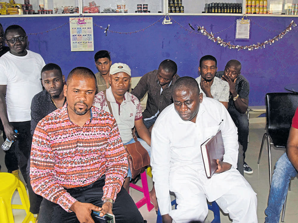 Nigerian Community and Students Bangalore (NCSB) India members hold a meeting after the death of Ifeanyi Madu, a Nigerian national, in the city on Monday. DH&#8200;photo