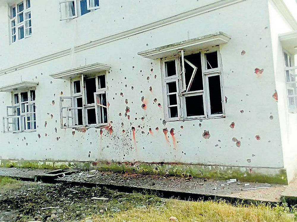 Marks of mortar shells are seen on the wall of the Chakkan Da Bagh building after shelling from the Pakistan side in  Malti sector of Poonch district in Jammu and Kashmir on Monday. PTI