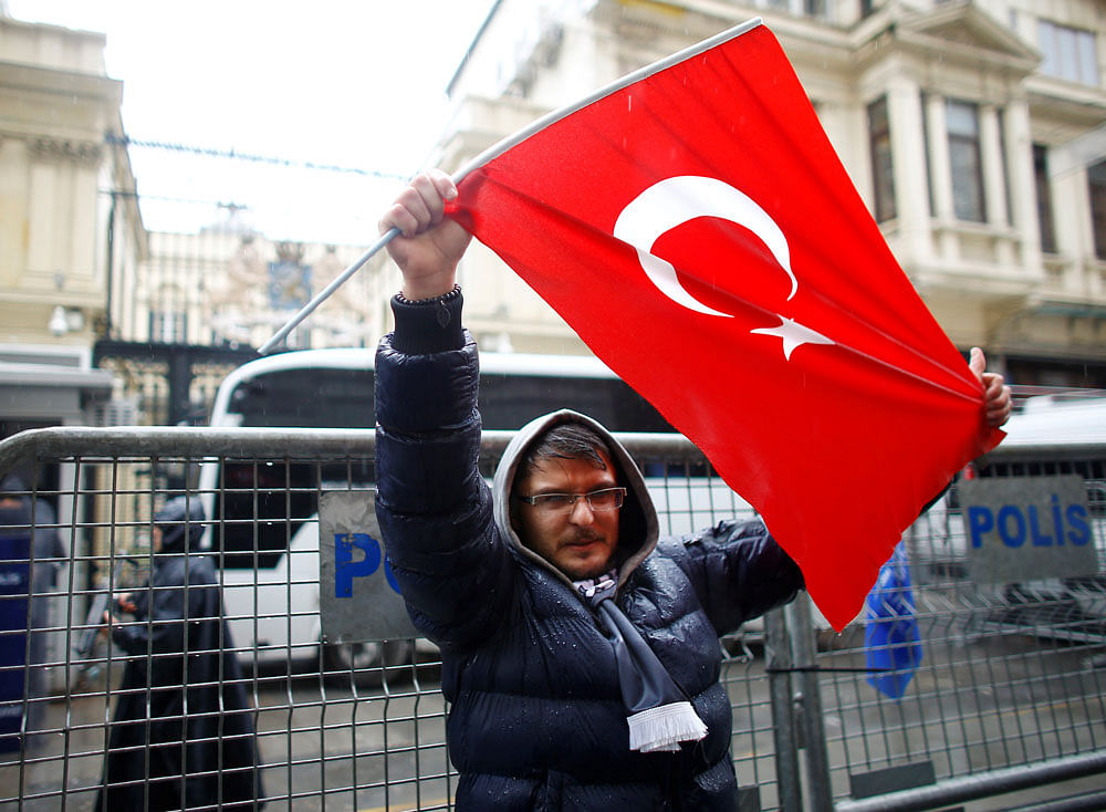 CONCERNED: A demonstrator holds a Turkish flag during a protest in front of the Dutch Consulate in Istanbul, Turkey, March 12, 2017. REUTERS