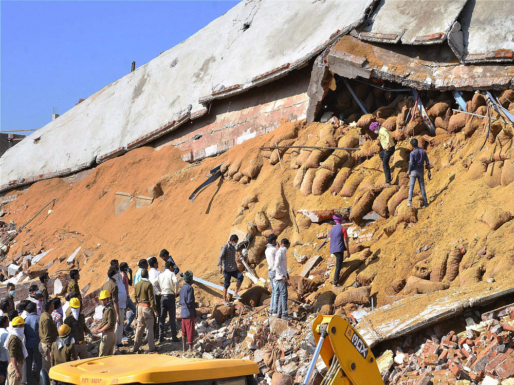 Police investigate at the debris of cold storage building that collapsed due to an explosion triggered by gas leak in its chiller plant, at Shivrajpur in Kanpur district on Wednesday. PTI Photo