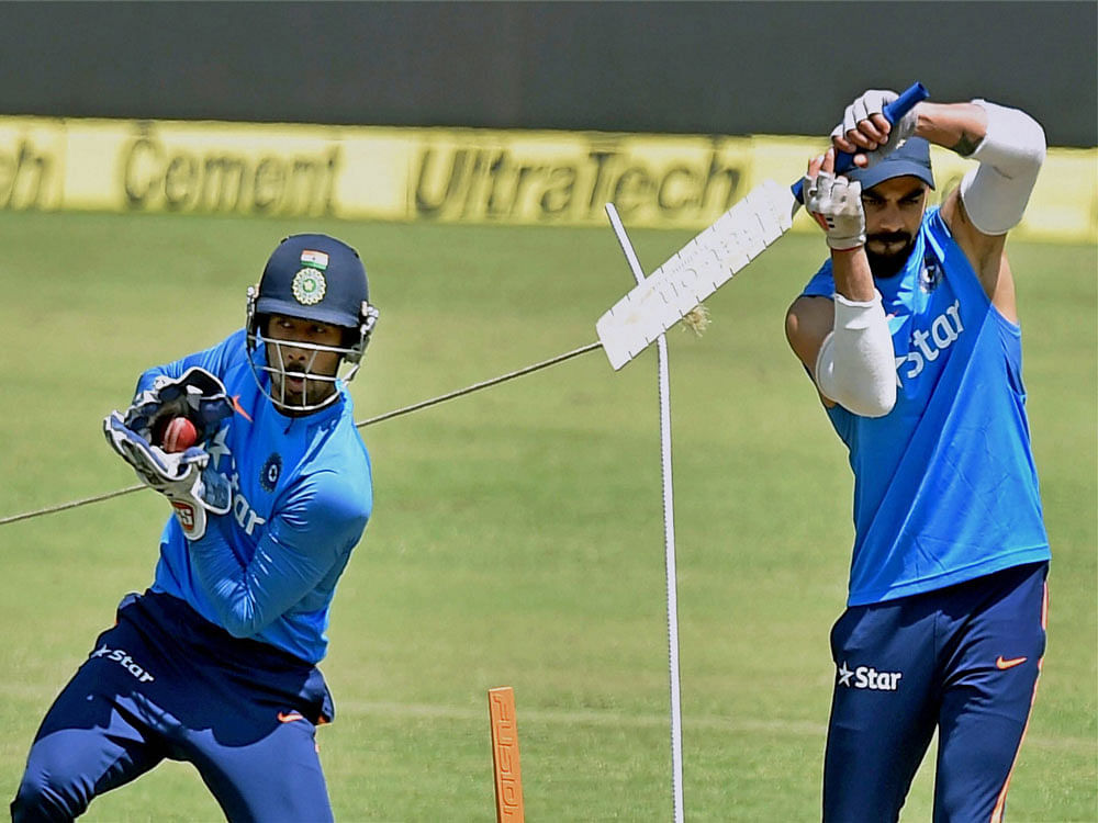 India captain Virat Kohli and wicketkeeper Wriddhiman Saha during a practice session before the third Test match against Australia, in Ranchi on Wednesdsay. PTI Photo