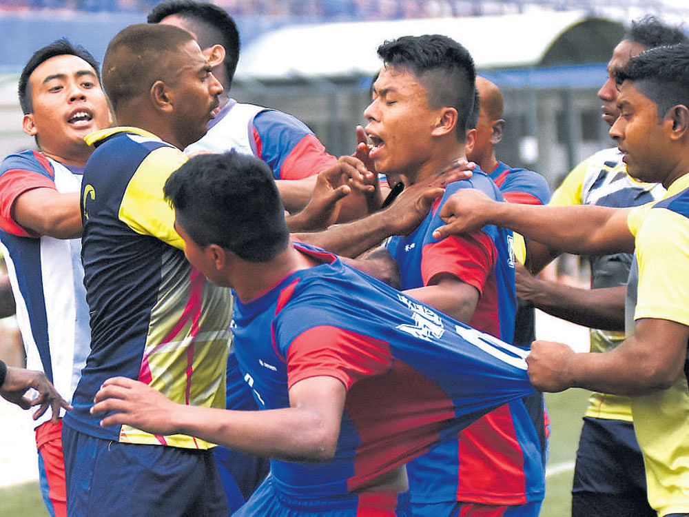 feisty encounter: MEG and ASC players get into a tussle during their BDFA Super Division League encounter at the Bangalore Football Stadium on Thursday. DH PHOTO/B H Shivakumar