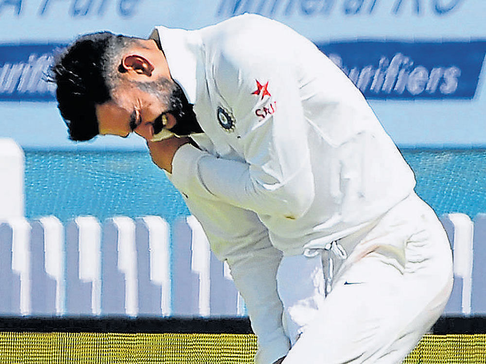 Ouch Indian captain Virat Kohli holds his shoulder in pain  after making a diving save at the boundary. AFP