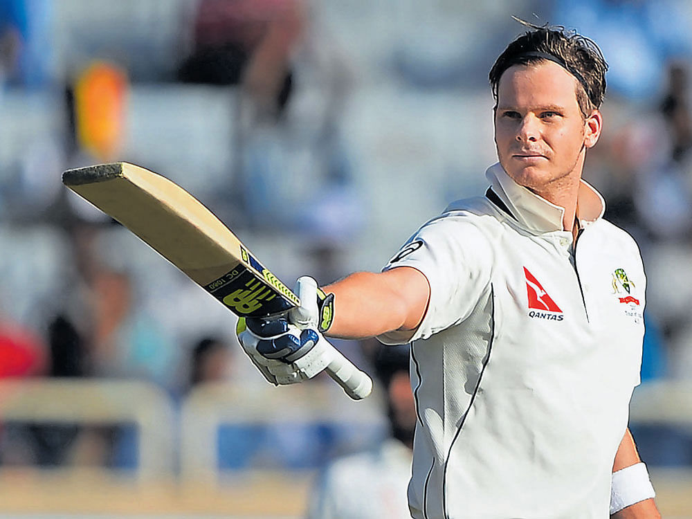leading the way: Australia's Steve Smith celebrates his century on the opening day of the third Test in Ranchi. AFP