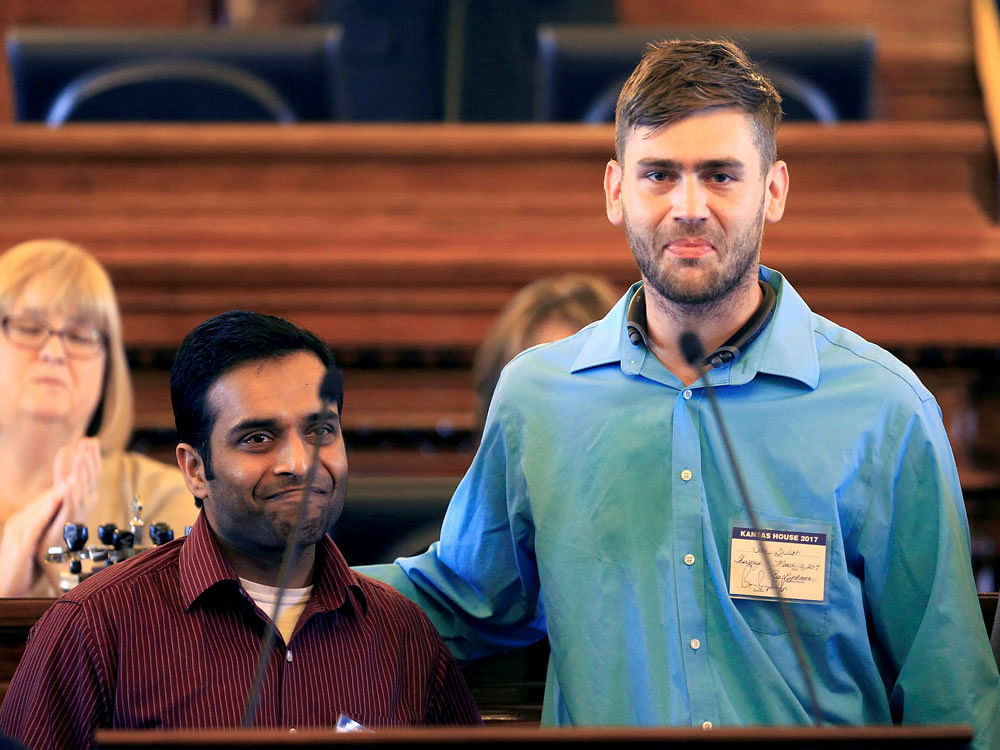 Alok Madasani, left, and Ian Grillot, right, embrace and smile after they were honored by the Kansas House of Representatives in Topeka, Kan., Thursday, March 16, 2017. House Speaker Ron Ryckman, Jr. recognized the two survivors of last month's shooting at an Olathe bar and commemorated Srinivas Kuchibhotla, who died in the shooting. House members also passed a resolution honoring Kuchibhotla's life. AP/PTI