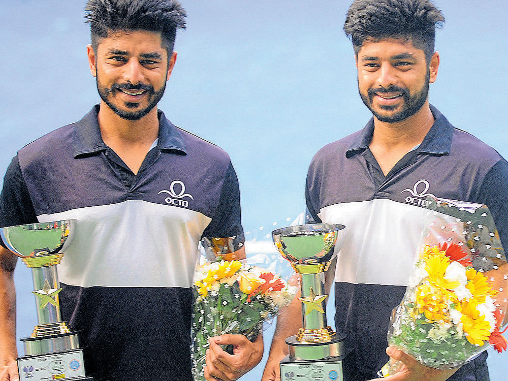 Twin tReat: Sood brothers Lakshit (left) and Chandri with the ITF Futures doubles trophy at the KSLTA courts in Bengaluru on Friday. Dh photo