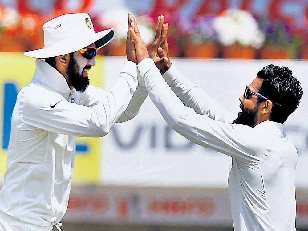 Well done: India's Ravindra Jadeja (right) celebrates Mathew Wade's wicket with team-mate KL Rahul on Friday. AFP