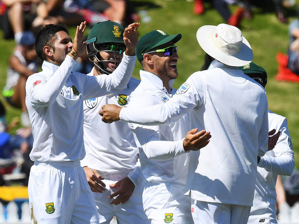 South Africa's Keshav Maharaj, left, celebrates with teammates after dismissing New Zealand's Jeet Raval during the second cricket test at the Basin Reserve, Wellington, New Zealand. AP/PTI Photo