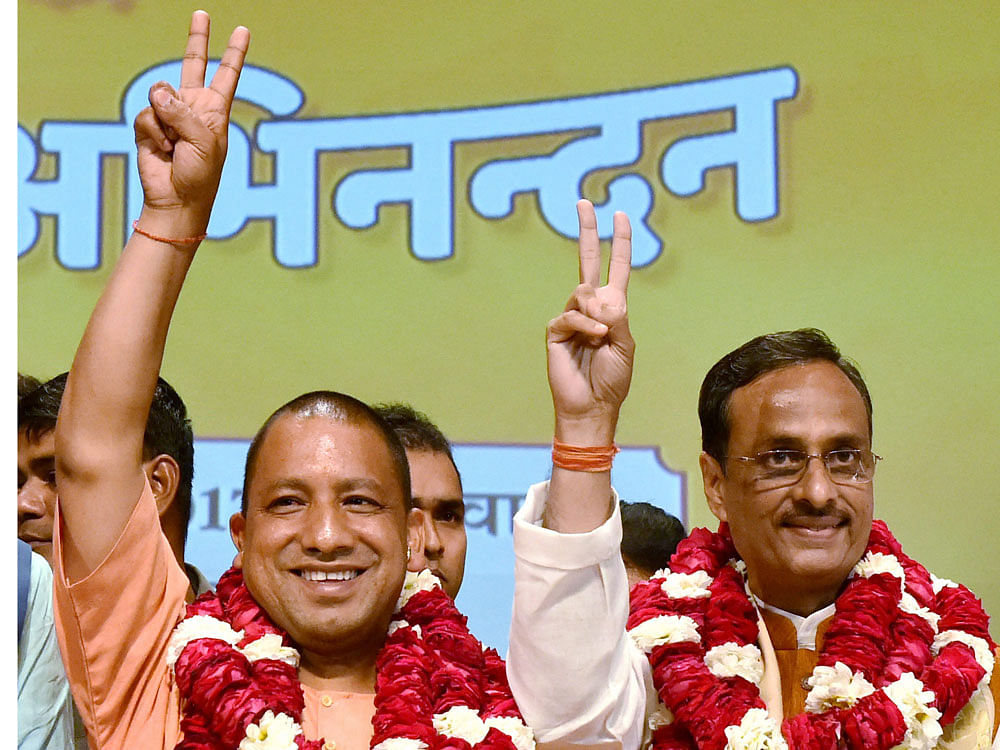 Yogi Adityanath (L) elected leader of the BJP Legislature Party (Chief Minister Uttar Pradesh) Deputy CM) Dinesh Sharma (R) in Lucknow on Saturday.PTI Photo