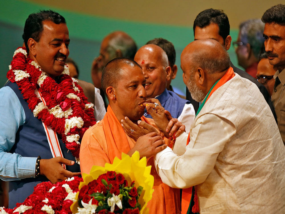 India''s ruling Bharatiya Janata Party leader Yogi Adityanath is offered sweets after he was elected as Chief Minister of India's most populous state of Uttar Pradesh, during the party lawmakers' meeting in Lucknow. Reuters Photo