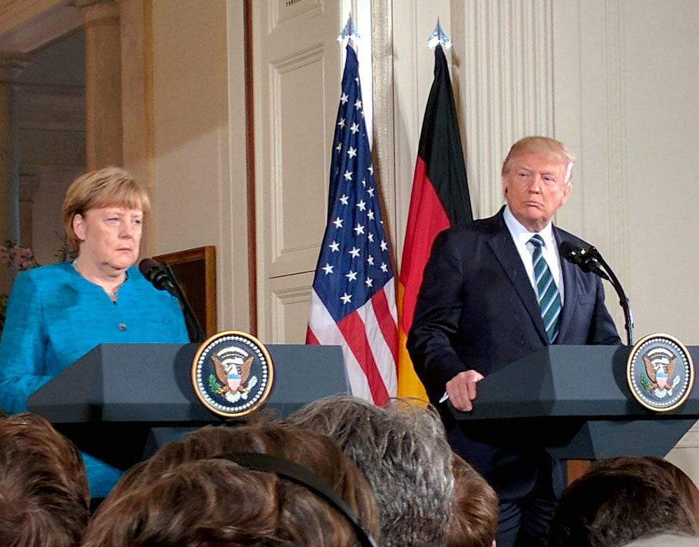 US President Donald Trump and the visiting German Chancellor Angela Merkel addressing a joint news conference at the White House in Washington DC non Friday. PTI Photo