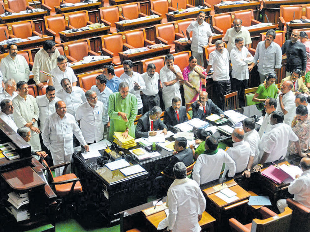 Opposition BJP and JD(S) members argue with Chief Minister Siddaramaiah in the Legislative Assembly on Tuesday, seeking fulfilment of demands of anganwadi workers . DH photo