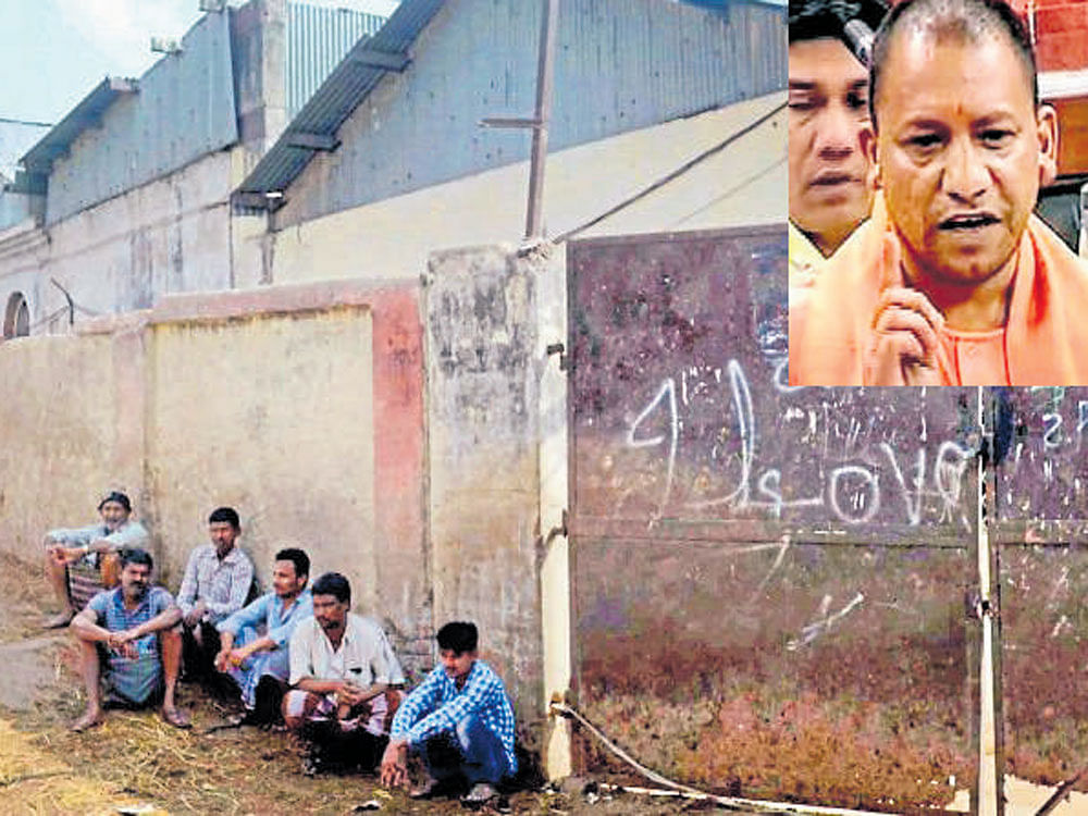 People sit outside a slaughterhouse that was sealed by the authorities in Allahabad on Tuesday. Shutting illegal slaughterhouses was one of the poll promises made by the BJP  and Adityanath (inset) made a veiled reference to it in the  Lok Sabha on Tuesday. PTI