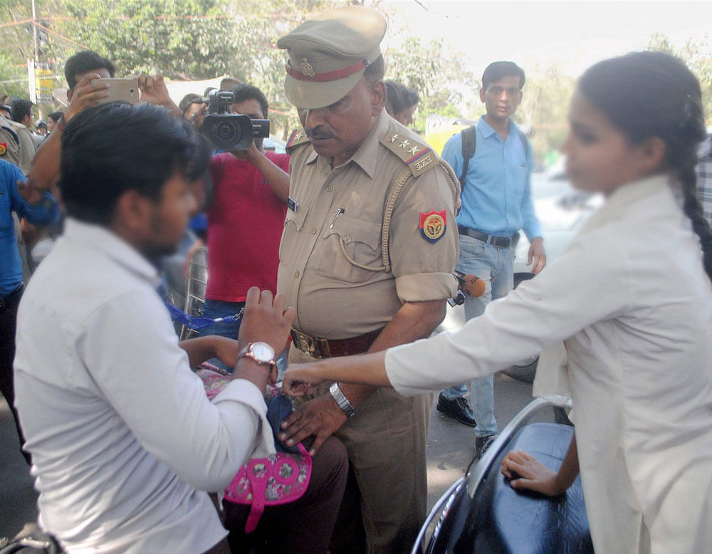 Anti-Romeo squad of police hauls up a youth in Lucknow on Wednesday. 'Anti-Romeo squads' ordered by new Chief Minister of Uttar Pradesh, Yogi Adityanath have started work across the state. PTI Photo