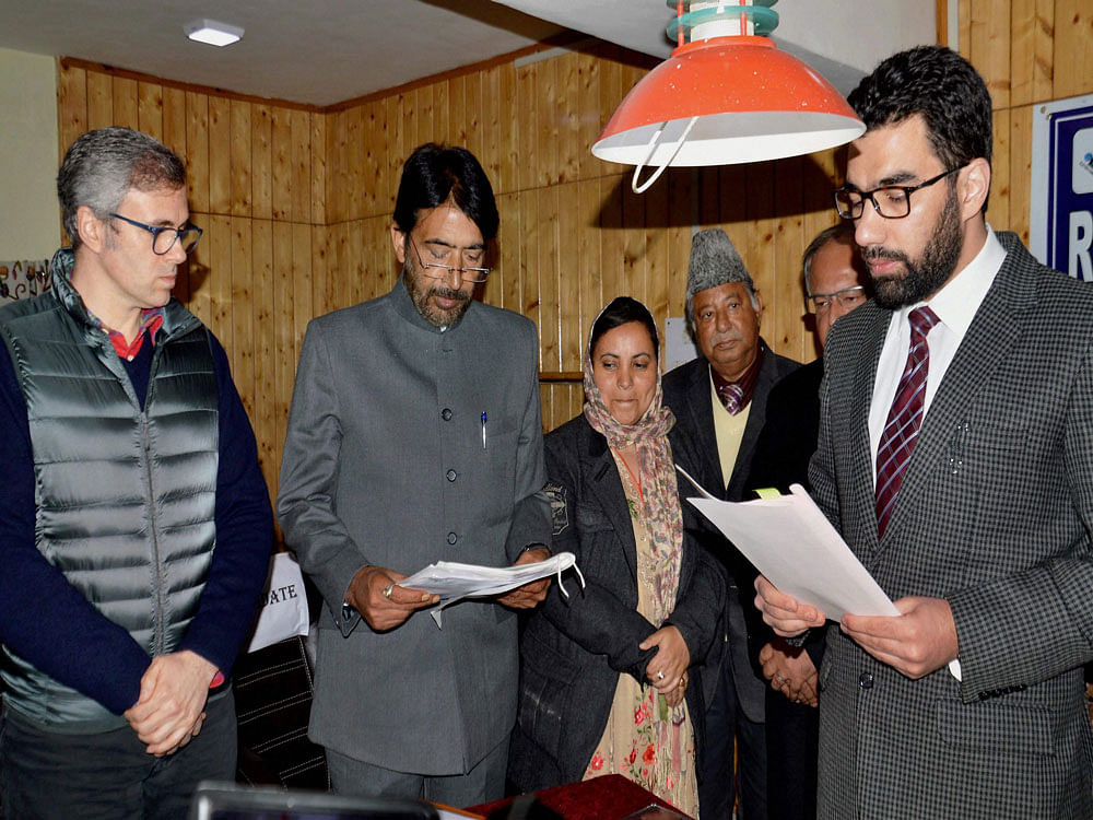 Jammu and Kashmir Congress chief Ghulam Ahmad Mir, along with former chief minister Omar Abdullah, filing nomination papers for Anantnag Parliamentary bypoll seat, at DC office in Anantnag on Wednesday. PTI Photo