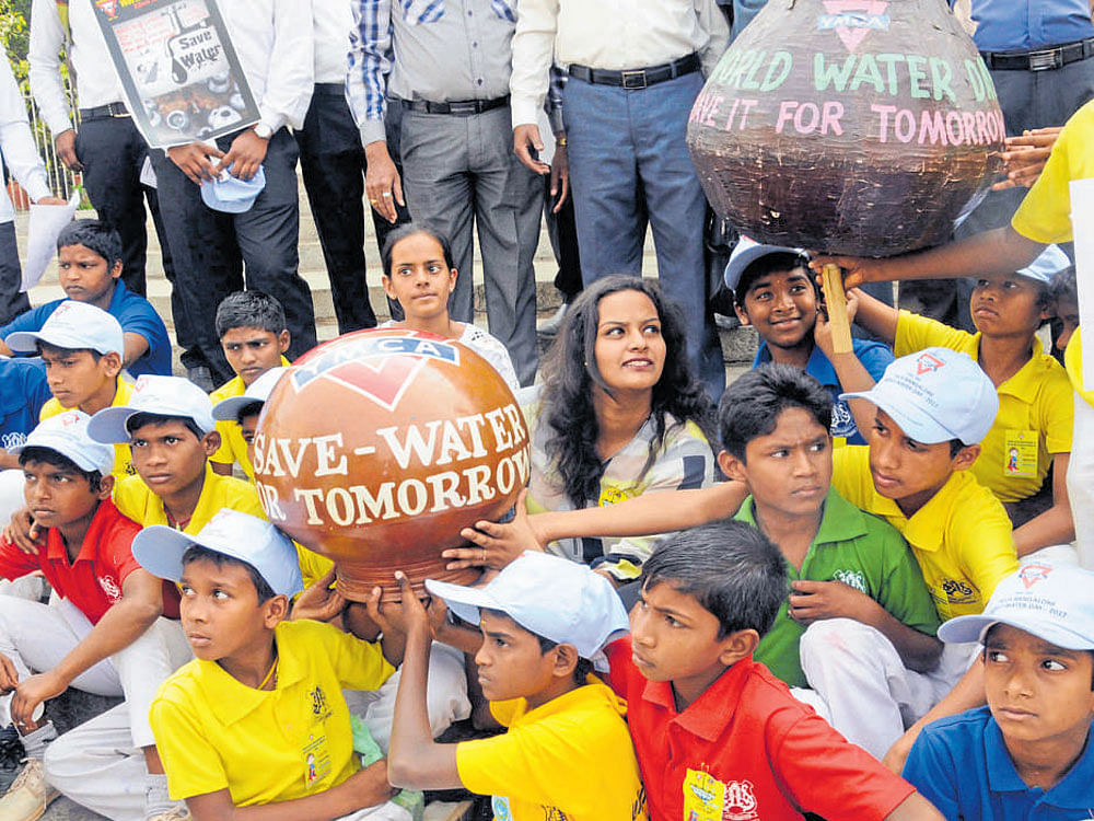 Schoolchildren take part in an awareness programme as part of World Water Day in front of Town Hall on Wednesday. dh photo