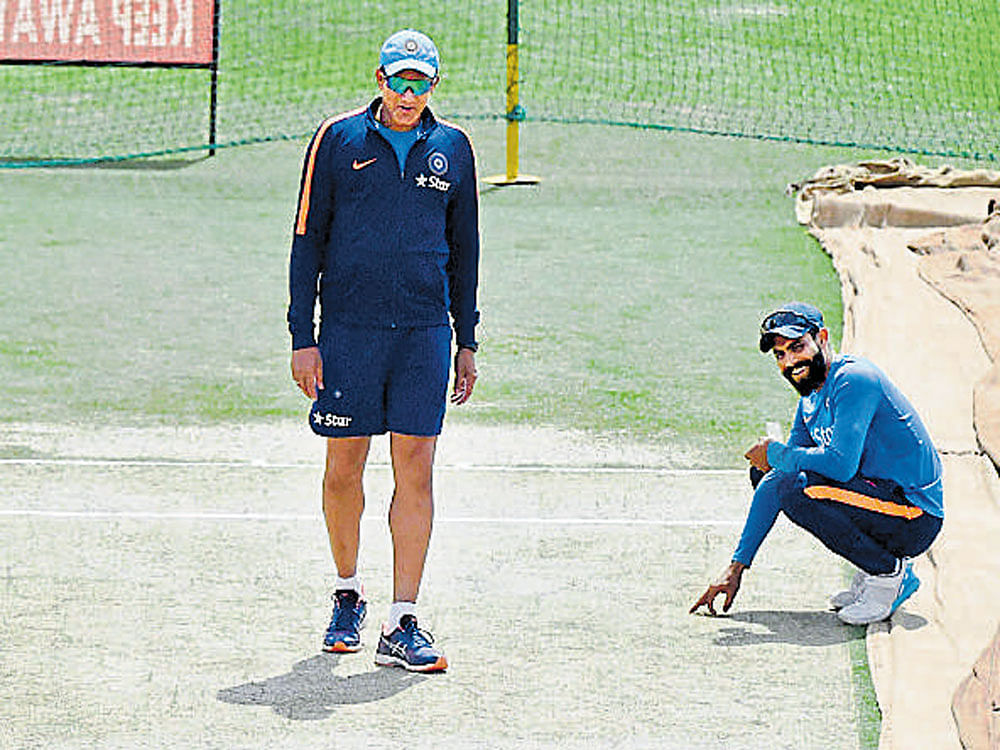 getting a heads up India coach Anil Kumble (left) and spinner Ravindra Jadeja inspect the Dharamsala pitch. pti