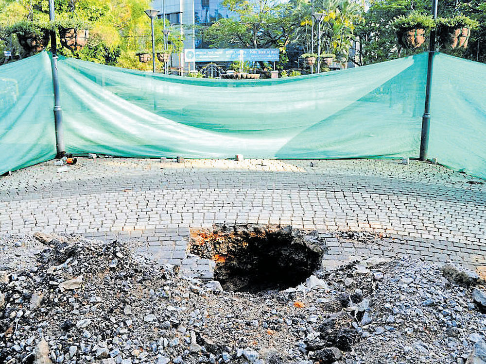 A pit dug up on the footpath near SBI office on St Mark's Road to repair an electricity line. DH&#8200;Photo