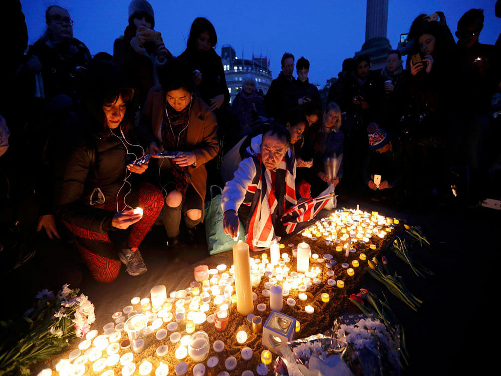 People light candles at a vigil in Trafalgar Square the day after an attack, in London, Britain March 23, 2017. REUTERS