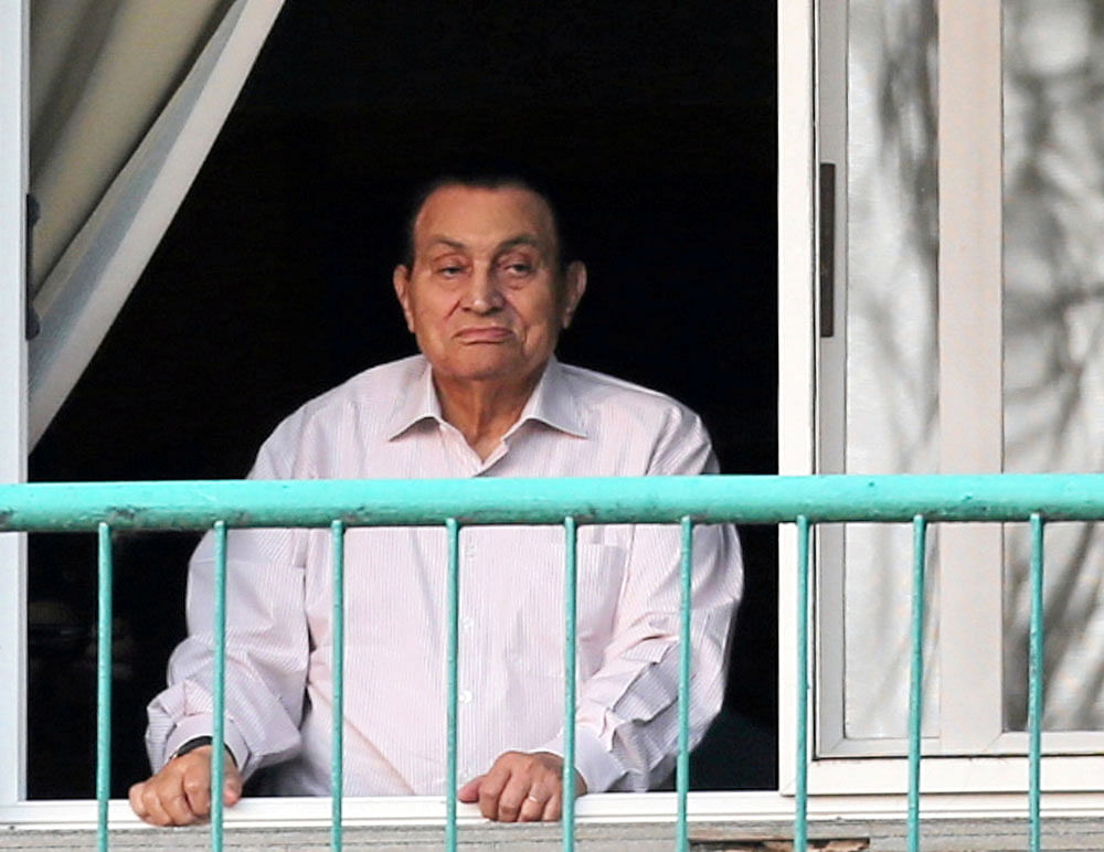 Ousted Egyptian president Mubarak looks towards his supporters outside the area where he is hospitalized during the celebrations of the 43rd anniversary of the 1973 Arab-Israeli war, at Maadi military hospital. reuters file photo