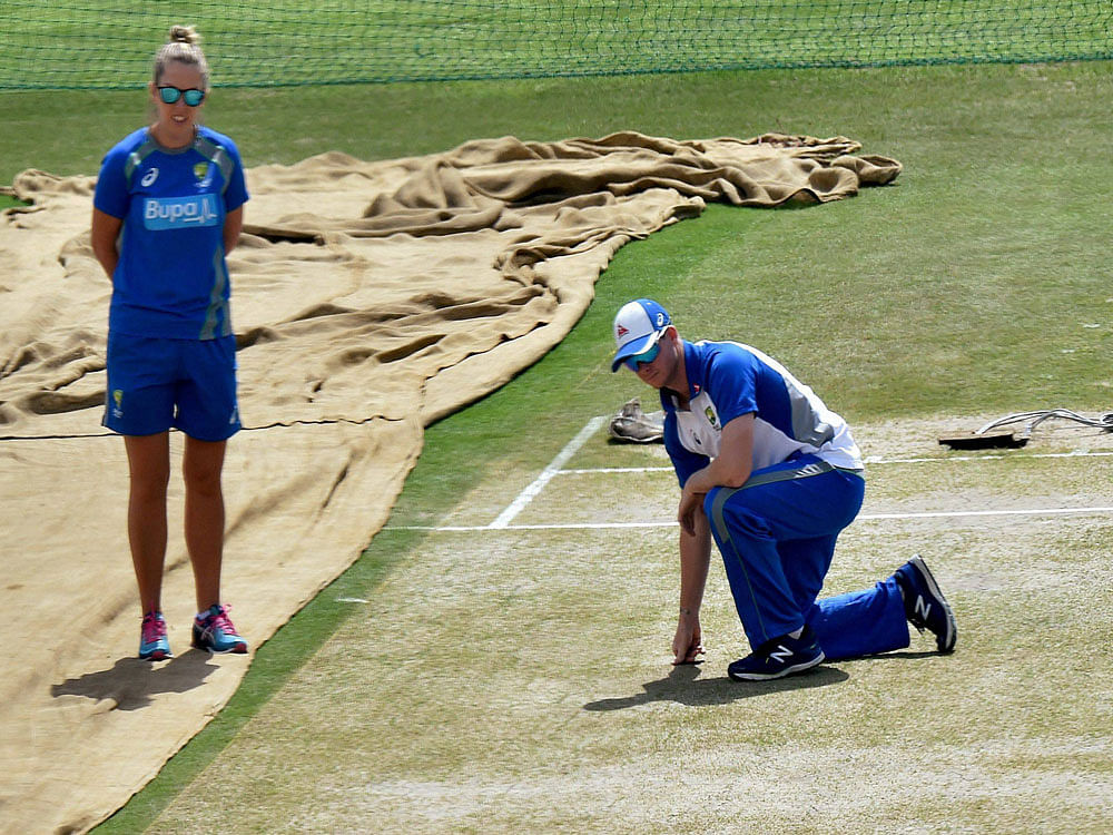 Australian cricket captain Steve Smith inspecting the pitch at HPCA Stadium in Dharamsala on Friday ahead of the final Test match. PTI Photo